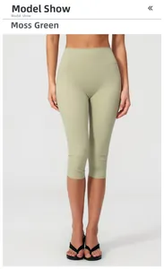 Macro detail of high-waist moss green yoga shorts with premium brushed texture fabric