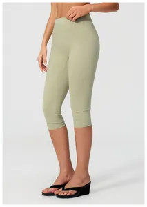 Side view of high-waisted seamless green yoga shorts with stretchy brushed fabric texture