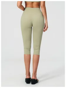 Rear view of high-waist yoga shorts in sage green showing butt-lifting seam details
