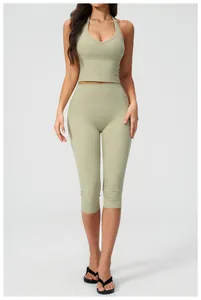Front view of grey-green halter crop top and high waist yoga capris for women