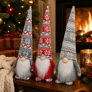 Close-up of three festive Christmas gnomes with knitted snowflake hats in cozy home decor