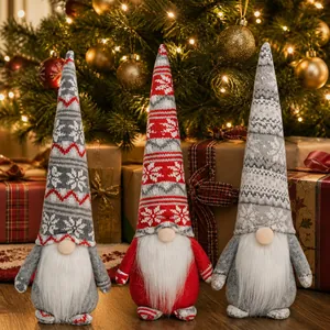 Three Christmas gnomes with knit snowflake hats and long white beards on festive background