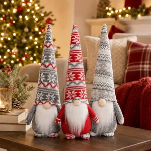 Detailed close-up of three knit Christmas gnomes with snowflake hats and long white beards
