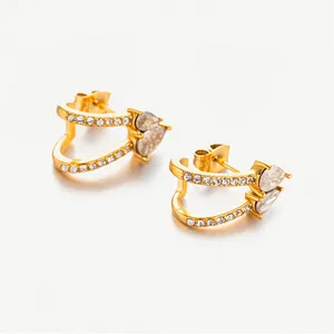 Close-up of gold plated C-shape heart earrings with micro-set zircon and pear-cut stones