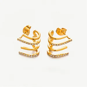 Detailed view of triple-layered C-shape gold earrings with sparkling zircon inlay