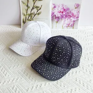 Fashionable baseball caps in black and white with colorful sparkling rhinestones