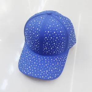 Close-up of sparkling blue rhinestones on a stylish baseball cap with curved brim
