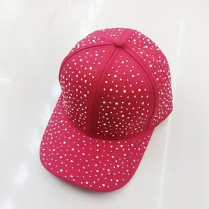 Macro shot of hot pink baseball cap with shimmering rhinestones and curved brim