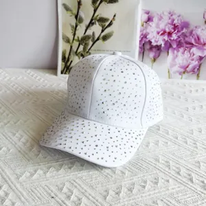 Detail of white baseball cap with colorful rhinestones on premium cotton fabric