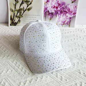 Close-up of white baseball cap with colorful rhinestones on a decorative background