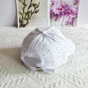 Rear view of white baseball cap with colorful rhinestones and adjustable metal buckle