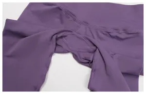 Detail of high-waist ribbed band and reinforced gusset on dark purple yoga leggings