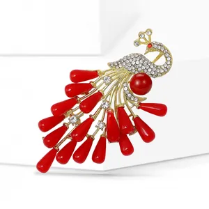 Exquisite gold peacock brooch with red resin beads and sparkling crystal rhinestones