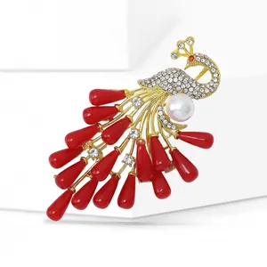 Detailed macro view of peacock brooch with gold finish, white pearls and red gems