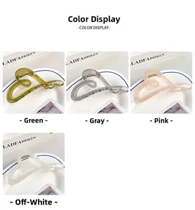 Detailed color display of translucent heart hair claws in green, grey, pink, and cream