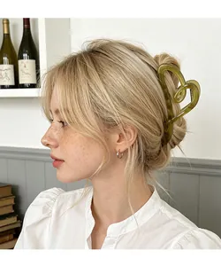 Detail of vintage translucent olive green heart hair claw clip on model hair style