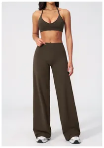 Detail of high-waist wide-leg sports trousers in olive green with brushed texture fabric