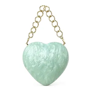 Elegant heart-shaped light green acrylic evening bag with marble texture and gold chain