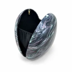 Detail view of heart-shaped acrylic evening bag with colorful marble texture and gold clasp