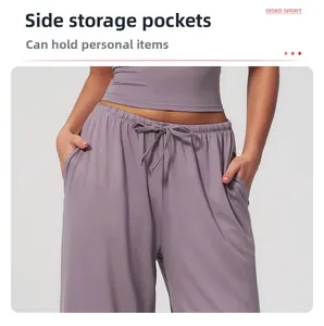 Detail of practical side pockets and drawstring waist on purple wide leg yoga pants