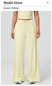 Detail of cream yellow wide-leg lounge pants with elastic drawstring waist for women