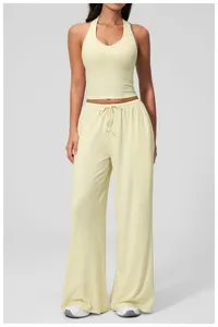 Detailed view of women's yellow wide-leg lounge pants with drawstring and halter top