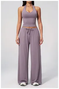 Detail showing the purple wide-leg pants with drawstring and halter crop top set