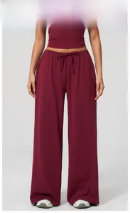 Detail of high-waist cherry red wide-leg sweatpants with drawstring and soft texture