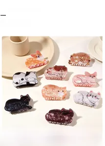 Detail showing various animal-shaped acetate hair claw clips with marble texture