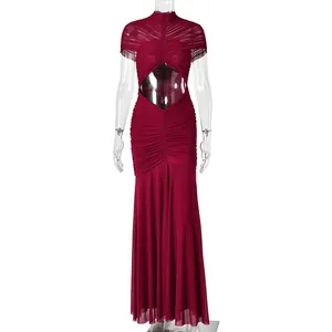 Detail of burgundy evening gown featuring ruched waist cut-outs and halter neckline