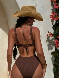 Detail of dark brown ribbed bikini back with elegant lace-up bow design on high waist suit