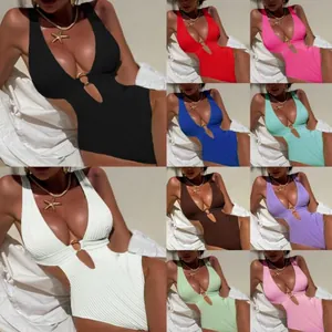 Detail of ribbed texture and V-neckline with metal ring on one-piece swimsuit
