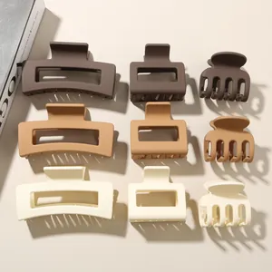 Detailed view of matte geometric shark hair clips in neutral earth tones for women