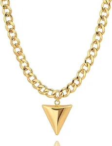 Macro detail of 14K gold plated curb chain necklace with polished cone pendant
