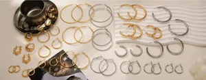 Collection of gold and silver hoop earrings in various sizes and twisted textures