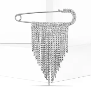 Macro detail of luxury silver brooch with cascading diamond-studded fringe chains