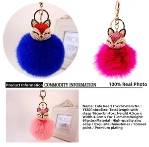 Close-up of royal blue, rose, and pink faux fur pompom fox keychains with rhinestones