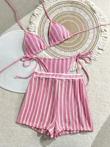 Detail of pink striped crochet bikini top and shorts set with woven textures