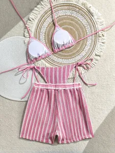 Detailed flat lay of pink and white striped three-piece bikini with knitted texture fabric