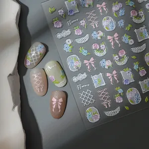 Detail of 5D embossed nail stickers featuring blue roses, bows and lace patterns