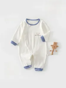 Detail of breathable white baby romper with blue trim and cute cartoon bear print