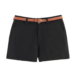 Detail of black casual shorts featuring a brown synthetic leather belt and side pockets