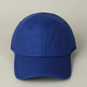 Close-up of deep blue cotton linen baseball cap showing detailed fabric texture and stitching