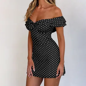Close-up of the sweetheart neckline with ruffle details on the polka dot mini dress
