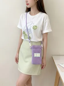 Fresh purple mesh crossbody phone bag with strap shown on model in summer outfit