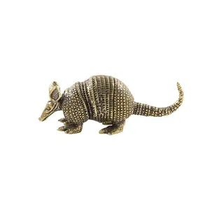 Detailed macro view of vintage brass pangolin figurine with intricate scale texture