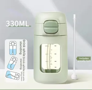 Detailed view of 330ml baby straw cup with gravity ball and clear scale markings