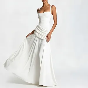 Detail view of white slim fit maxi dress with elegant waist pleats and draped fabric