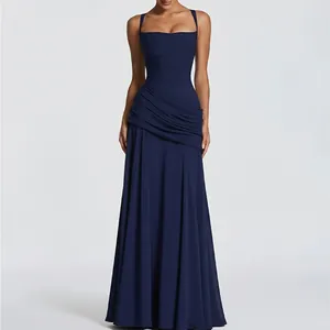 Close-up of navy blue ruched bodice and flowing pleated fabric on a long A-line dress