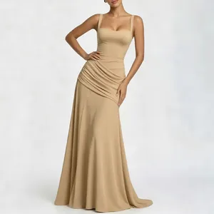 Detail of champagne evening dress featuring square neck straps and waist pleats